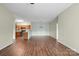 Open-plan living area with dining space and updated kitchen featuring wood floors at 10720 Hill Point Ct, Charlotte, NC 28262