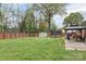 Spacious backyard featuring a gazebo, trampoline, storage shed, volleyball net, and full privacy fence at 1121 Rembrandt Sw Dr, Concord, NC 28027