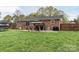 Brick home's spacious backyard includes a gazebo, grill, and trampoline at 1121 Rembrandt Sw Dr, Concord, NC 28027