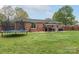 Brick home's spacious backyard features a gazebo, grill, and trampoline at 1121 Rembrandt Sw Dr, Concord, NC 28027