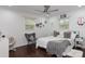 Bedroom featuring a bed, gray chair, a ceiling fan, hardwood floors, and two large windows at 1121 Rembrandt Sw Dr, Concord, NC 28027