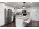 Stylish kitchen boasts granite counters, an island with seating, and stainless steel appliances at 1121 Rembrandt Sw Dr, Concord, NC 28027