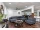 Spacious open-concept living room with hardwood floors, a large sectional sofa, and a dining area in the background at 1121 Rembrandt Sw Dr, Concord, NC 28027