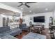 Open living area showcases hardwood floors, a modern kitchen, and comfortable seating with a large-screen television at 1121 Rembrandt Sw Dr, Concord, NC 28027