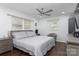 Cozy main bedroom with a ceiling fan, two windows, and a neutral color palette at 1121 Rembrandt Sw Dr, Concord, NC 28027