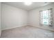 Bright bedroom with neutral carpet, natural light, and patterned curtains at 123 Abersham Dr, Mooresville, NC 28115