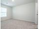 Bright bedroom with plush carpeting and natural light from large window at 123 Abersham Dr, Mooresville, NC 28115