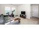 Bright bonus room featuring a Peloton bike, comfortable sofa, and TV for relaxing and entertaining at 123 Abersham Dr, Mooresville, NC 28115