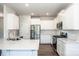 Modern kitchen with stainless steel appliances, quartz countertops, and white cabinets at 123 Abersham Dr, Mooresville, NC 28115
