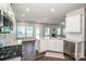 Open kitchen with white cabinets, quartz countertops, and stainless steel appliances at 123 Abersham Dr, Mooresville, NC 28115
