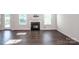 Cozy living room with fireplace, natural light, and hardwood flooring at 123 Abersham Dr, Mooresville, NC 28115