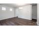 Bright living room featuring hardwood floors, neutral walls, and stylish chandelier at 123 Abersham Dr, Mooresville, NC 28115