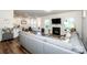 Spacious living area with hardwood floors, a gray sectional, fireplace, and open layout to the kitchen at 123 Abersham Dr, Mooresville, NC 28115