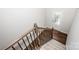 Carpeted staircase with wood banister, leading to a bright entrance, perfect for a welcoming home at 123 Abersham Dr, Mooresville, NC 28115
