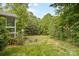 Spacious backyard with lush greenery and a cozy fire pit area for outdoor enjoyment at 1320 Huntcliff Dr, Waxhaw, NC 28173