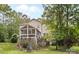 Secluded back yard with screened-in porch and fire pit surrounded by natural greenery at 1320 Huntcliff Dr, Waxhaw, NC 28173