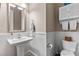Charming powder room with a pedestal sink, wainscoting, and neutral tones, exuding a classic appeal at 1320 Huntcliff Dr, Waxhaw, NC 28173