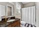 Well-lit bathroom featuring a vanity with granite countertops and a shower-tub combo, providing a clean and functional space at 1320 Huntcliff Dr, Waxhaw, NC 28173