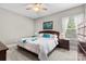 Bright bedroom with a queen-sized bed, ceiling fan, and a window for natural light creating a comfortable space at 1320 Huntcliff Dr, Waxhaw, NC 28173