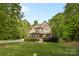 Charming two-story home with manicured lawn, mature trees, and a stone facade at 1320 Huntcliff Dr, Waxhaw, NC 28173