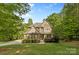 Charming two-story home with manicured lawn, mature trees, and a stone facade at 1320 Huntcliff Dr, Waxhaw, NC 28173