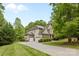 Charming two-story home with a well-manicured lawn, three-car garage and lush landscaping at 1320 Huntcliff Dr, Waxhaw, NC 28173