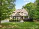 Charming two-story home with a stone and brick facade, lush landscaping, and a well-manicured lawn at 1320 Huntcliff Dr, Waxhaw, NC 28173