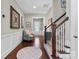 Entryway with hardwood floors, a staircase, and tasteful decor, creating a welcoming ambiance at 1320 Huntcliff Dr, Waxhaw, NC 28173