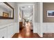 Inviting hallway with hardwood floors and white wainscoting, leading to a bright and spacious living area at 1320 Huntcliff Dr, Waxhaw, NC 28173