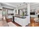 Bright kitchen island with black countertop, white cabinets, and hardwood floors at 1320 Huntcliff Dr, Waxhaw, NC 28173