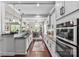 Modern kitchen with stainless steel appliances, dark countertops, white cabinets, and an adjacent dining area at 1320 Huntcliff Dr, Waxhaw, NC 28173
