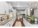 Modern kitchen featuring stainless steel appliances, granite countertops, and white cabinetry at 1320 Huntcliff Dr, Waxhaw, NC 28173