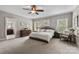 Spacious main bedroom with a plush bed, dresser, and natural light from two windows, creating a relaxing retreat at 1320 Huntcliff Dr, Waxhaw, NC 28173