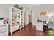 A view of a bright and functional home office area with a built-in bookshelf for storing books and office supplies at 1320 Huntcliff Dr, Waxhaw, NC 28173