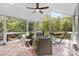Bright sunroom with large windows, comfortable seating, and a peaceful view of the surrounding nature at 1320 Huntcliff Dr, Waxhaw, NC 28173