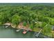 Aerial view of lakefront property with lush greenery, docks, and serene water at 1328 Astoria Pkwy, Catawba, NC 28609