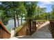 Scenic backyard featuring a wooden staircase leading to the lake at 1328 Astoria Pkwy, Catawba, NC 28609