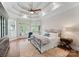 Bright bedroom with wood floors, a tray ceiling, lots of windows, and comfortable furniture at 1328 Astoria Pkwy, Catawba, NC 28609