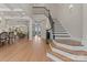 Open foyer with staircase showcasing hardwood floors, a decorative railing, and views into the adjacent living spaces at 1328 Astoria Pkwy, Catawba, NC 28609