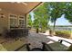 Outdoor patio with a dining set, lounge chairs, and views of the lake at 1328 Astoria Pkwy, Catawba, NC 28609