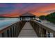 Picturesque lake dock with covered seating area offering stunning sunset views and waterfront access at 1328 Astoria Pkwy, Sherrills Ford, NC 28673
