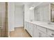 Bathroom with double vanity, modern lighting, wood-look tile flooring, and glass shower at 13756 Roderick Dr # 176, Huntersville, NC 28078