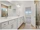 Primary bathroom with double vanity, modern fixtures, tile flooring, and glass enclosed shower at 13756 Roderick Dr # 176, Huntersville, NC 28078