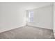Bright bedroom featuring neutral carpet and large window for lots of natural light at 13756 Roderick Dr # 176, Huntersville, NC 28078