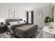 Stylish bedroom featuring a comfortable bed, modern decor, and a large window providing natural light at 13756 Roderick Dr # 176, Huntersville, NC 28078