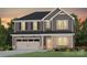 Charming two-story home featuring a two-car garage and a mix of siding and brick facade at 13756 Roderick Dr # 176, Huntersville, NC 28078