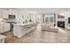 Spacious open-concept kitchen seamlessly connected to the living area with a fireplace and large windows at 13756 Roderick Dr # 176, Huntersville, NC 28078