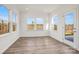Light-filled living room with many windows, neutral paint, and wood-look flooring at 13756 Roderick Dr # 176, Huntersville, NC 28078