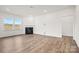 Bright living room with modern wood flooring, fireplace and natural light at 13756 Roderick Dr # 176, Huntersville, NC 28078