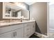Bathroom featuring double sink vanity with granite countertops, stylish cabinets, and modern fixtures at 1400 Fern Forest Dr, Gastonia, NC 28054